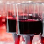 Diversi calici vicini tra loro pieni di "ratafià" un liquore sciropposo fatto di ciliegie selvatiche